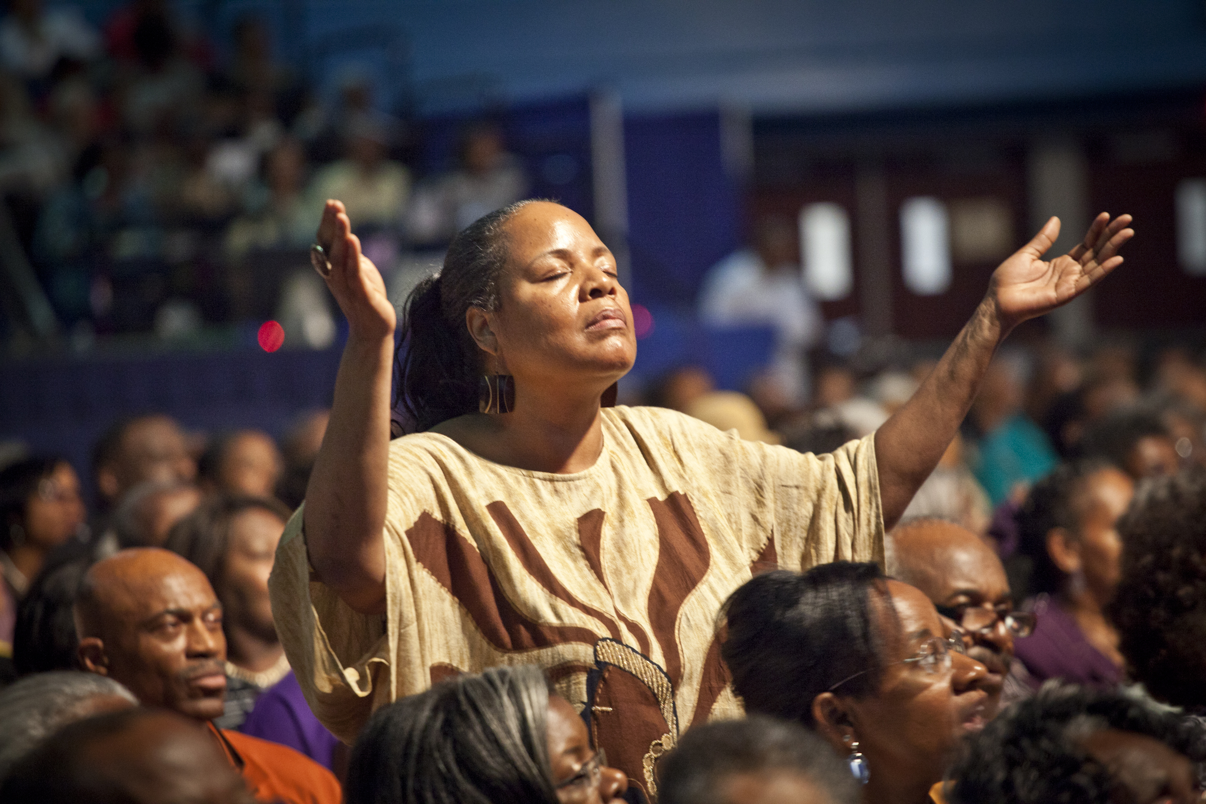 Woman with hands raised in praise | The DART Collective