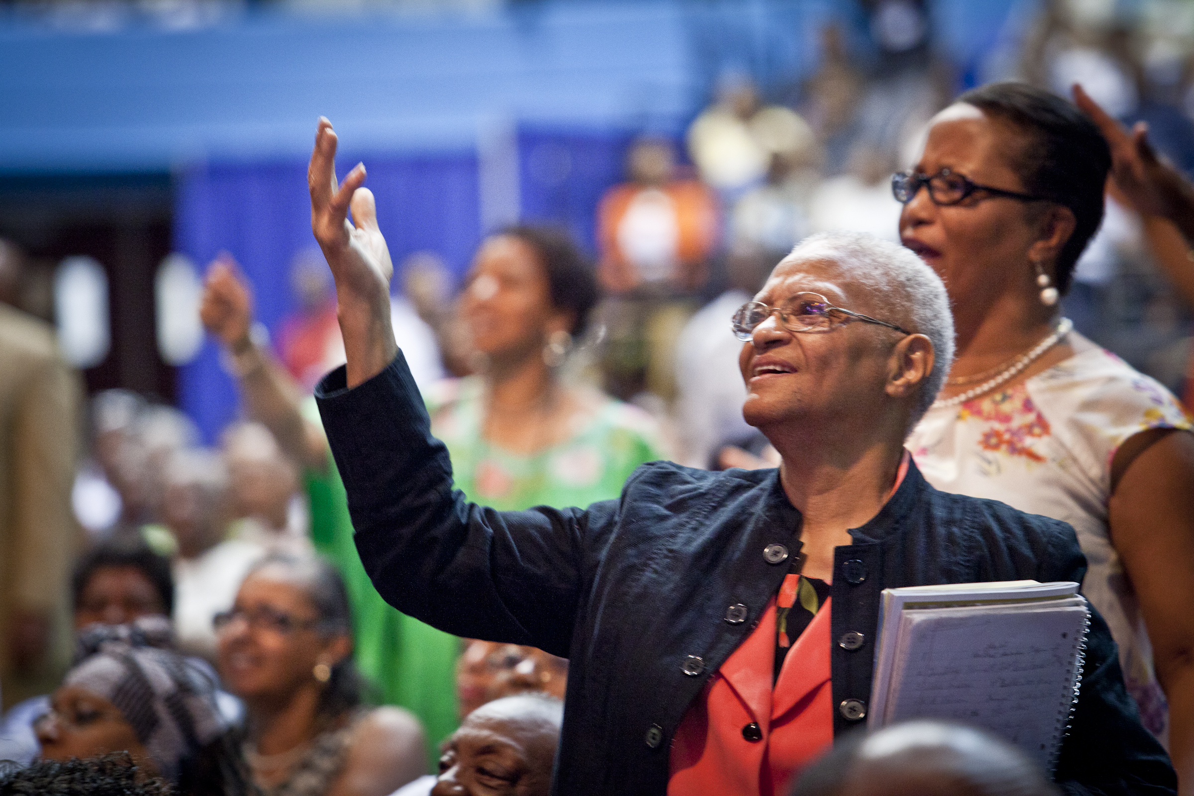 African American Woman hand raised in prayer | The DART Collective
