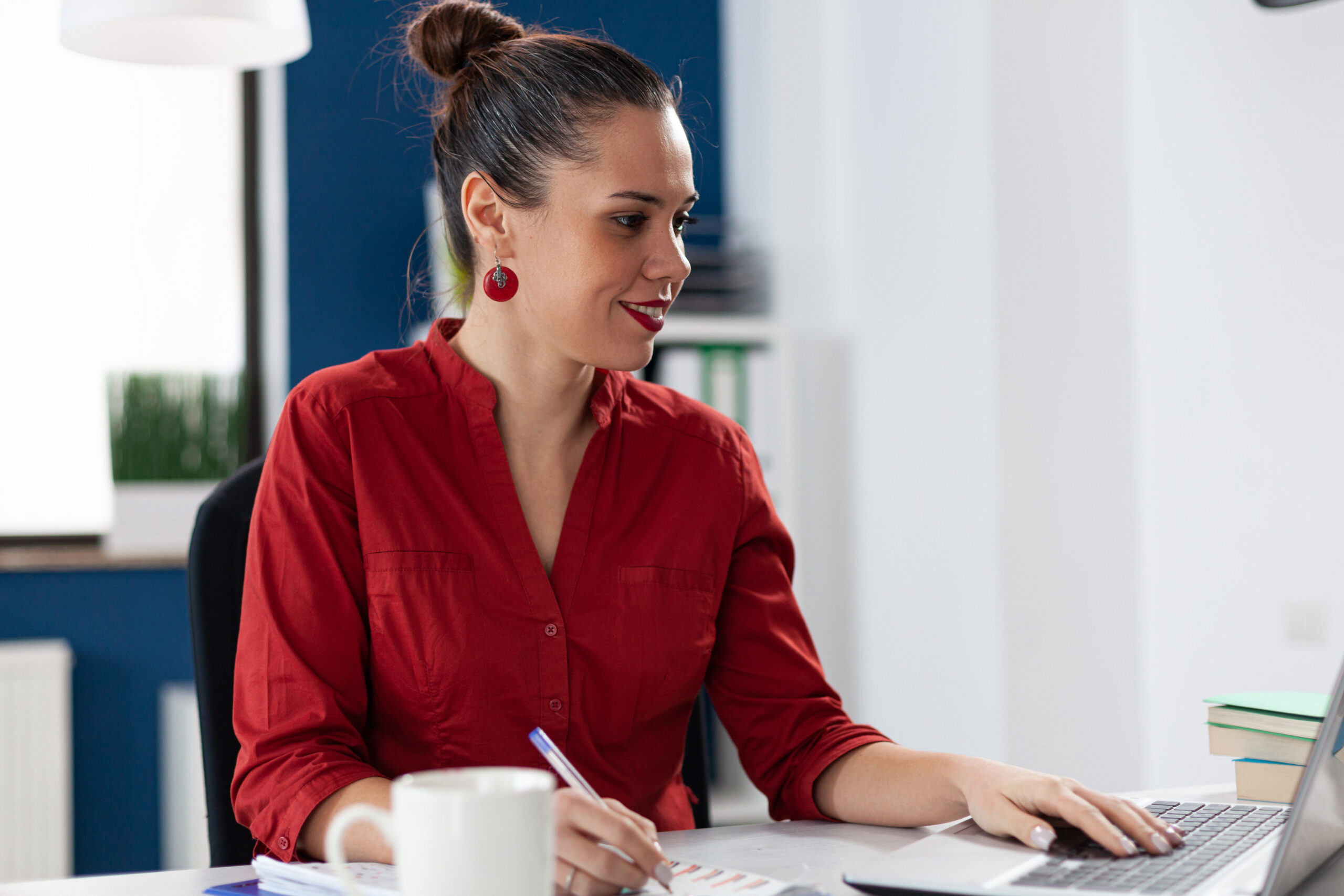 Smiling woman working in a office | The DART Collective